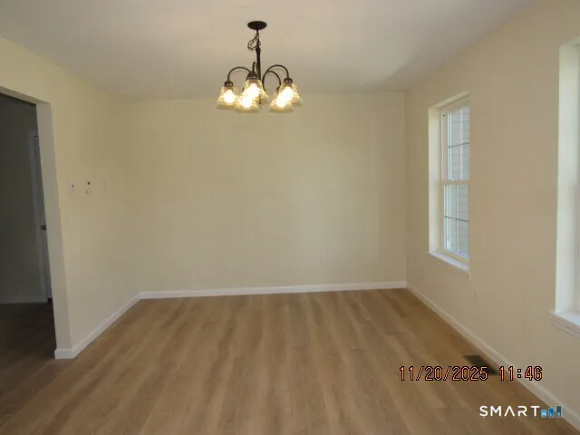 a view of water heater room with wooden floor