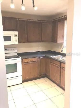 a kitchen with a stove top oven and cabinets