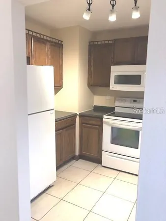 a kitchen with a refrigerator and a stove