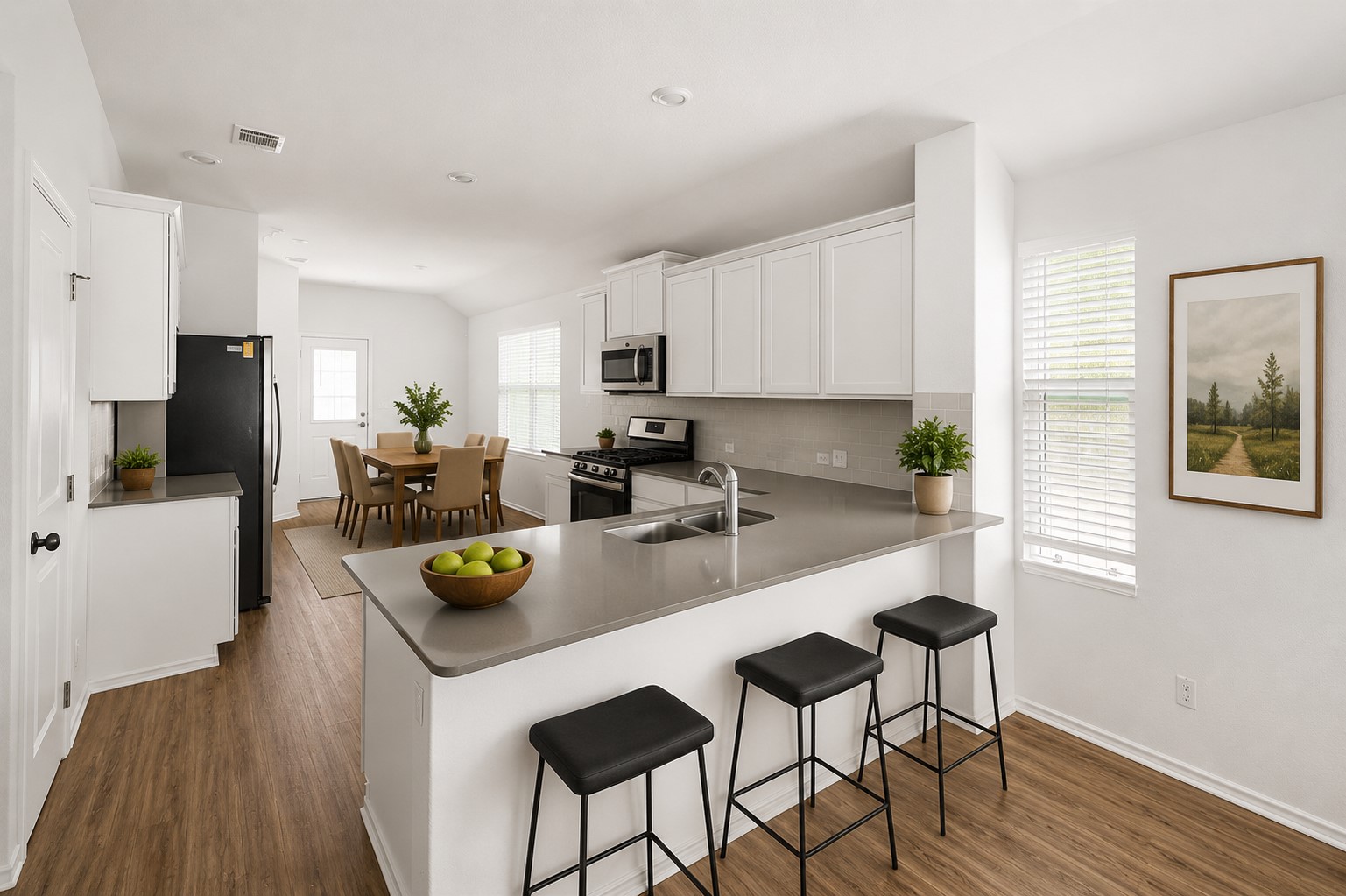 120 Milliner Loop Hutto, TX 78634 - Photo 4 of 15 A well-lit kitchen with sleek countertops and modern appliances, perfect for culinary adventures.