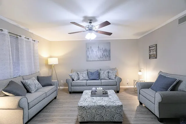 a living room with furniture and a large window