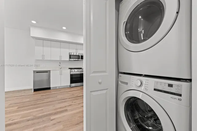 a view of a kitchen with a washer and dryer
