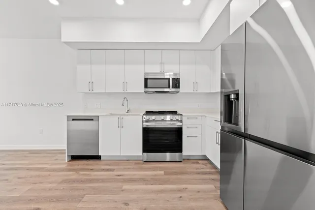 a kitchen with a refrigerator stove and microwave