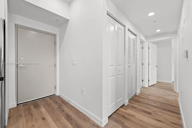 a view of a hallway with wooden floor