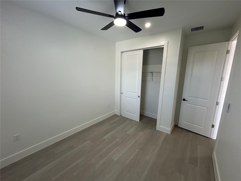 7361 South Plum Tree Punta Gorda, FL 33955 - Photo 13 of 14 an empty room with closet and a ceiling fan