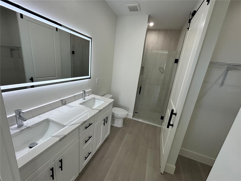7361 South Plum Tree Punta Gorda, FL 33955 - Photo 14 of 14 a bathroom with a double vanity sink and mirror with shower
