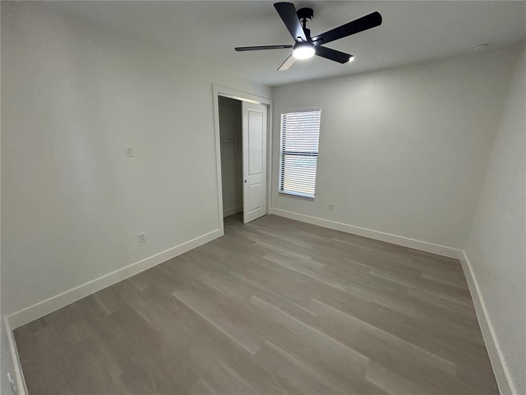 7361 South Plum Tree Punta Gorda, FL 33955 - Photo 5 of 14 an empty room with windows and fan