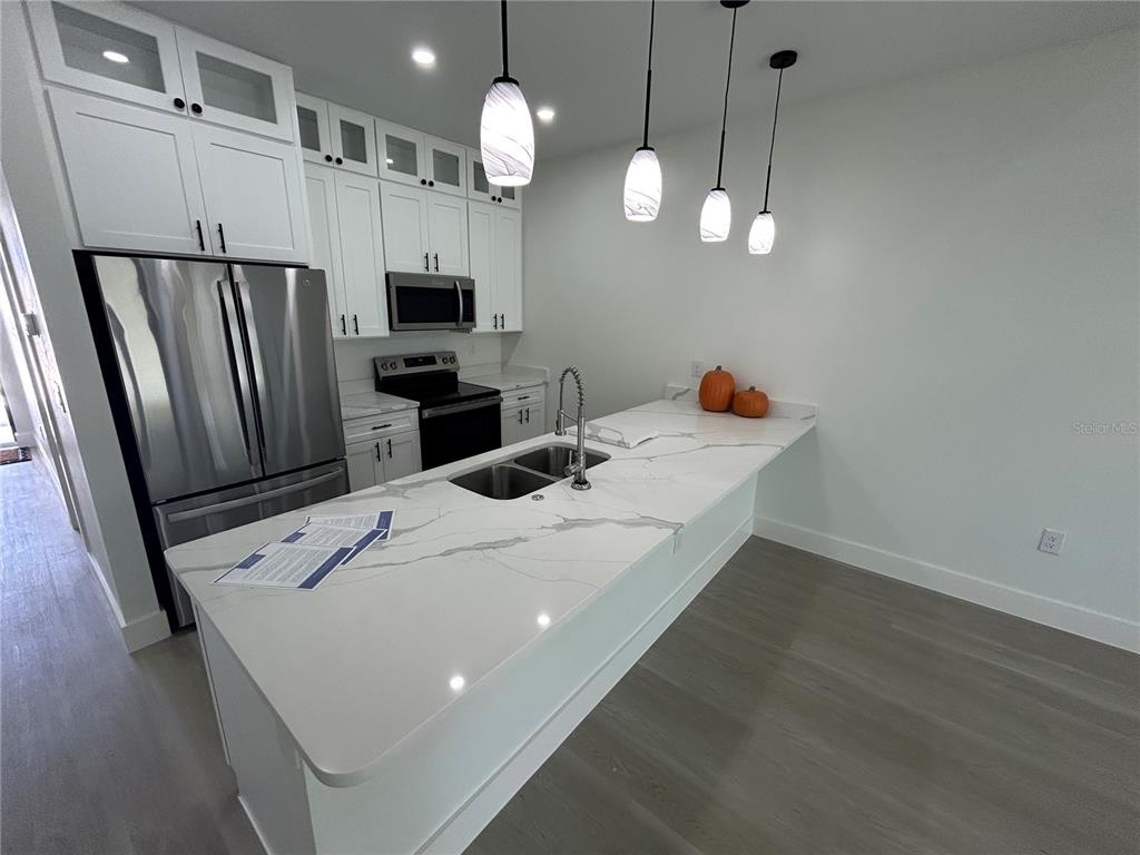 7361 South Plum Tree Punta Gorda, FL 33955 - Photo 7 of 14 a kitchen with stainless steel appliances a stove a refrigerator a sink and a fireplace
