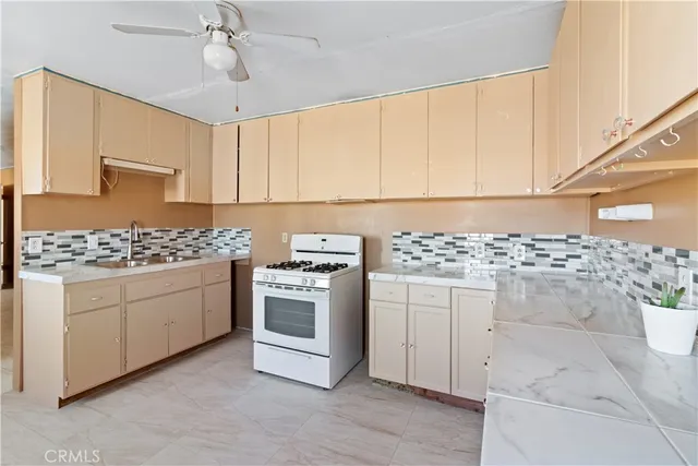 a kitchen with granite countertop white cabinets and white appliances