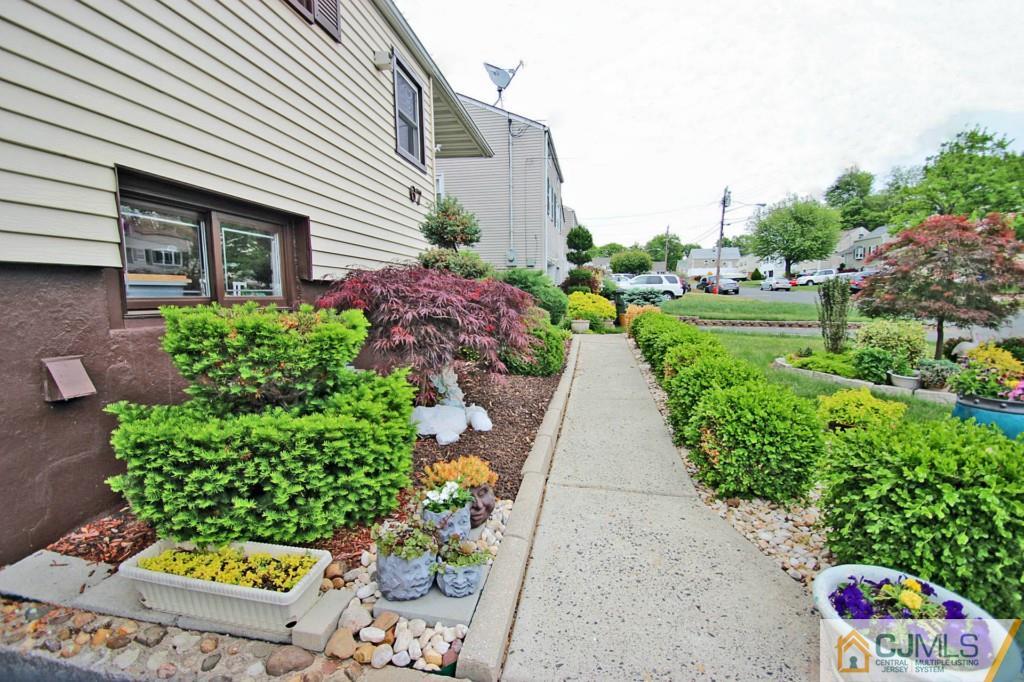 67 Brandywine Road Fords, NJ 08863 - Photo 2 of 25 a front view of a house with a yard and a garden