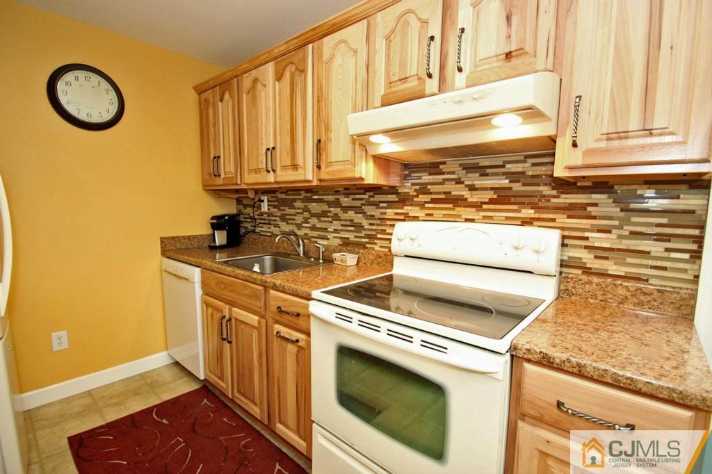 67 Brandywine Road Fords, NJ 08863 - Photo 11 of 25 a kitchen with granite countertop white cabinets and a sink