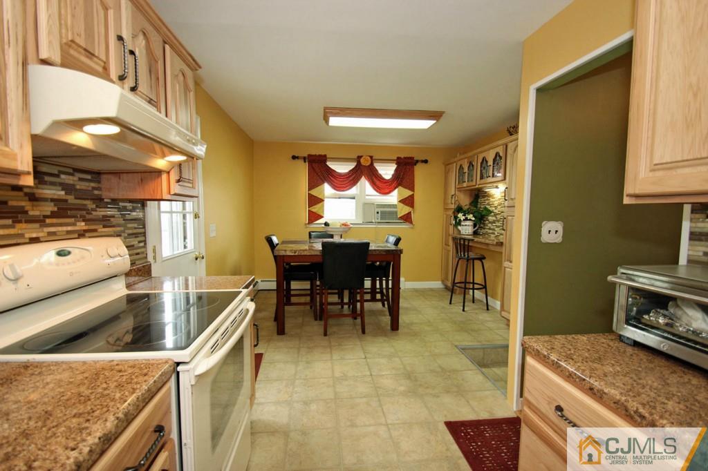 67 Brandywine Road Fords, NJ 08863 - Photo 13 of 25 a kitchen with stainless steel appliances granite countertop a sink and a stove