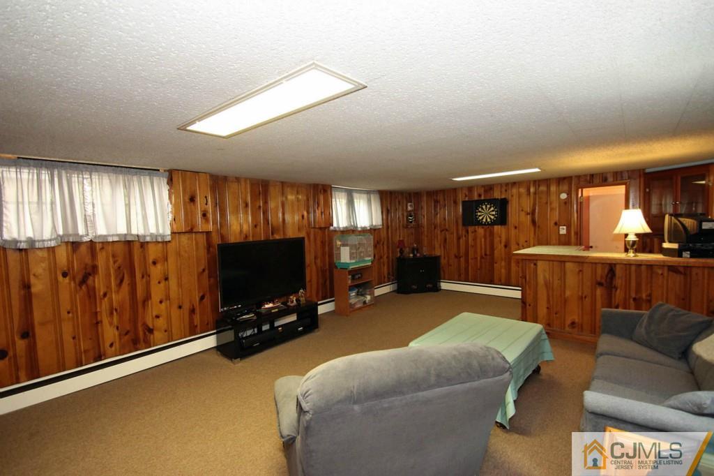 67 Brandywine Road Fords, NJ 08863 - Photo 16 of 25 a living room with furniture and a flat screen tv