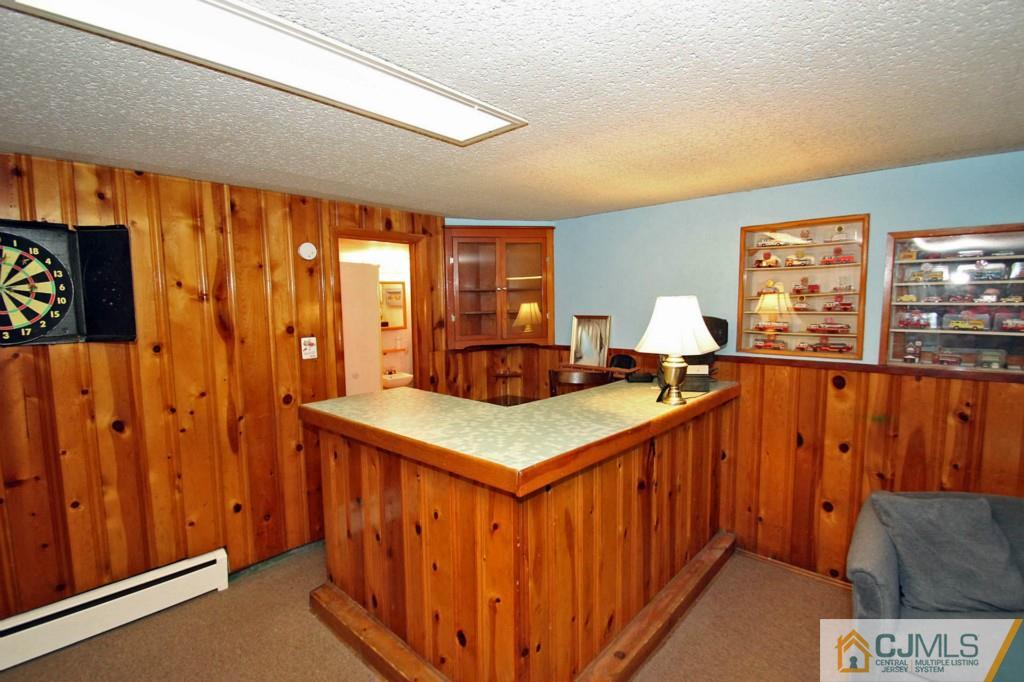 67 Brandywine Road Fords, NJ 08863 - Photo 18 of 25 a kitchen with stainless steel appliances kitchen island wooden cabinets and entryway