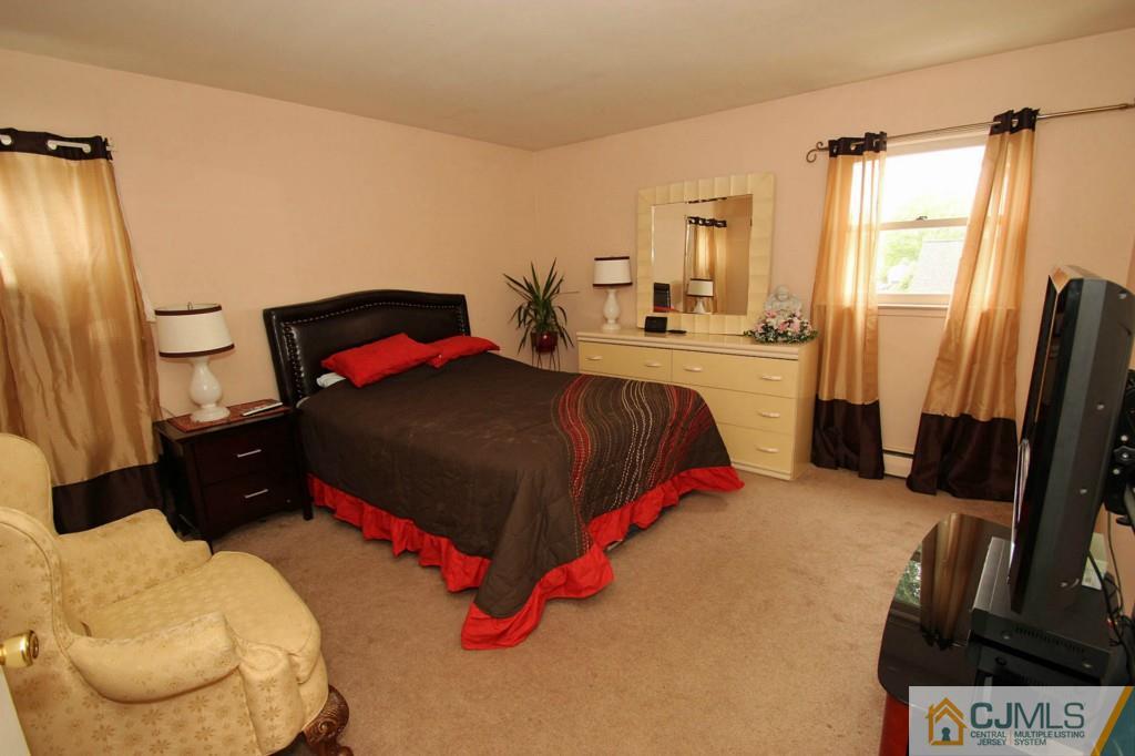 67 Brandywine Road Fords, NJ 08863 - Photo 19 of 25 a bedroom with a bed dresser and a window