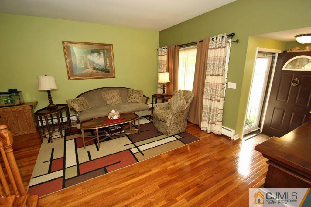 67 Brandywine Road Fords, NJ 08863 - Photo 5 of 25 a living room with furniture a wooden floor and next to a window