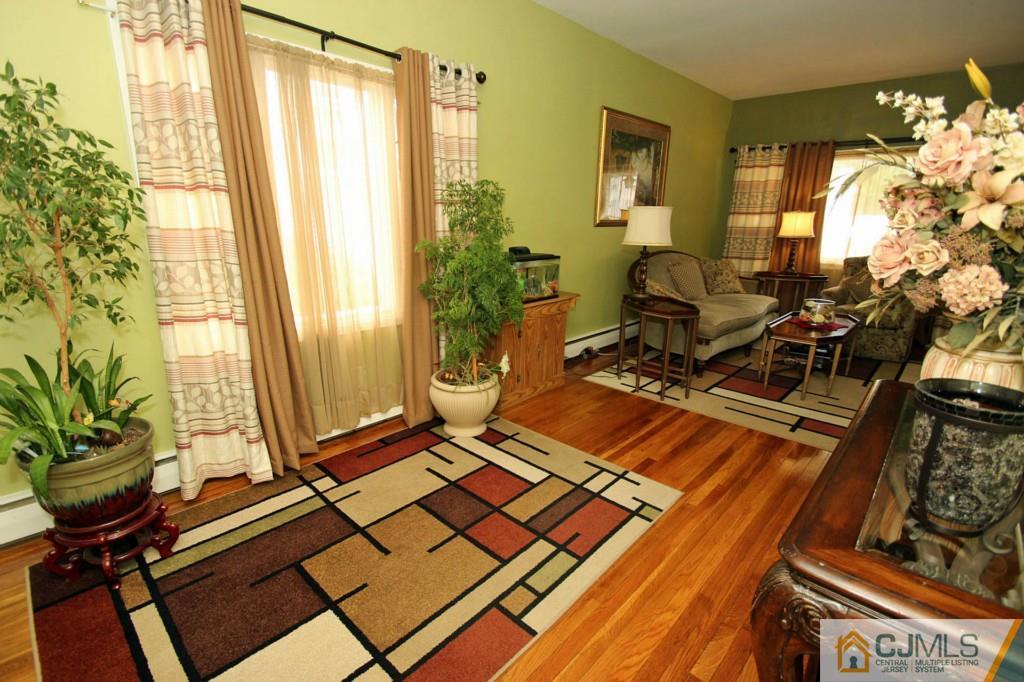 67 Brandywine Road Fords, NJ 08863 - Photo 10 of 25 a living room with a couch and a potted plant