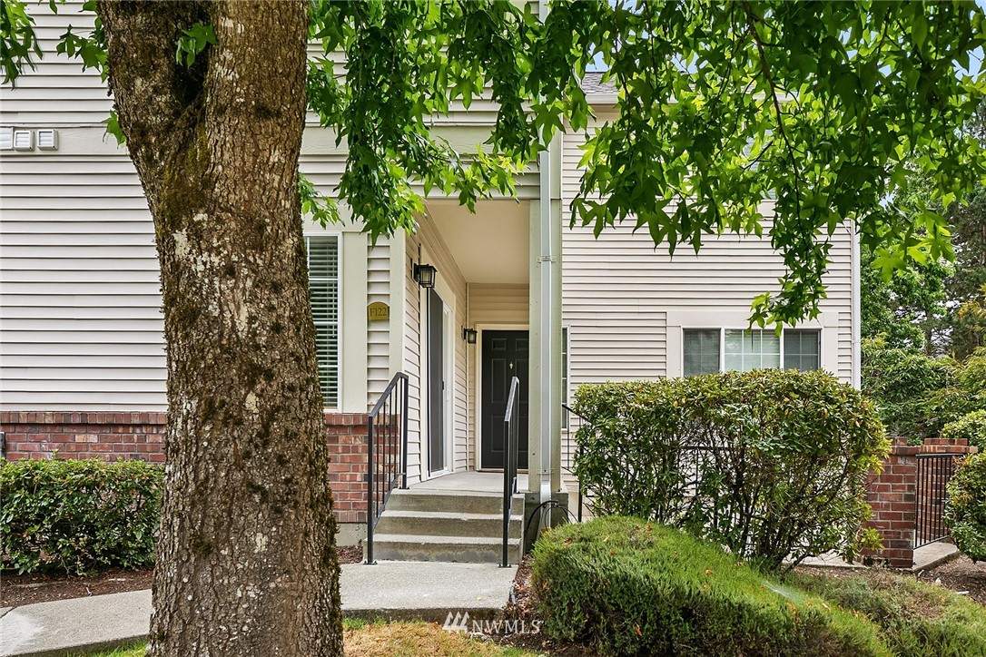 10909 Avondale Road Northeast, Unit F122 Redmond, WA 98052 - Photo 1 of 24 a view of a house with a tree