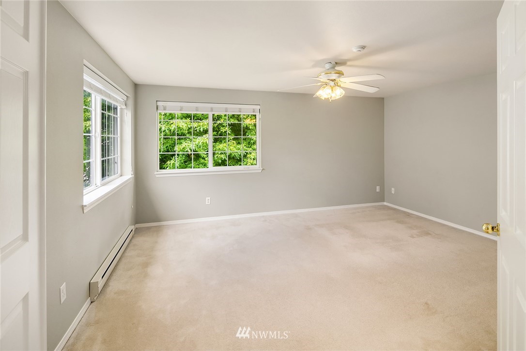 10909 Avondale Road Northeast, Unit F122 Redmond, WA 98052 - Photo 14 of 24 an empty room with windows and fan