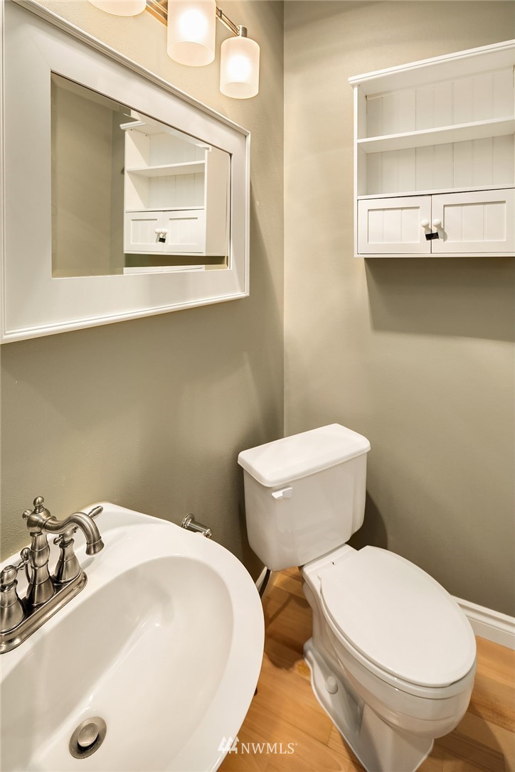 10909 Avondale Road Northeast, Unit F122 Redmond, WA 98052 - Photo 16 of 24 a bathroom with a toilet sink and mirror