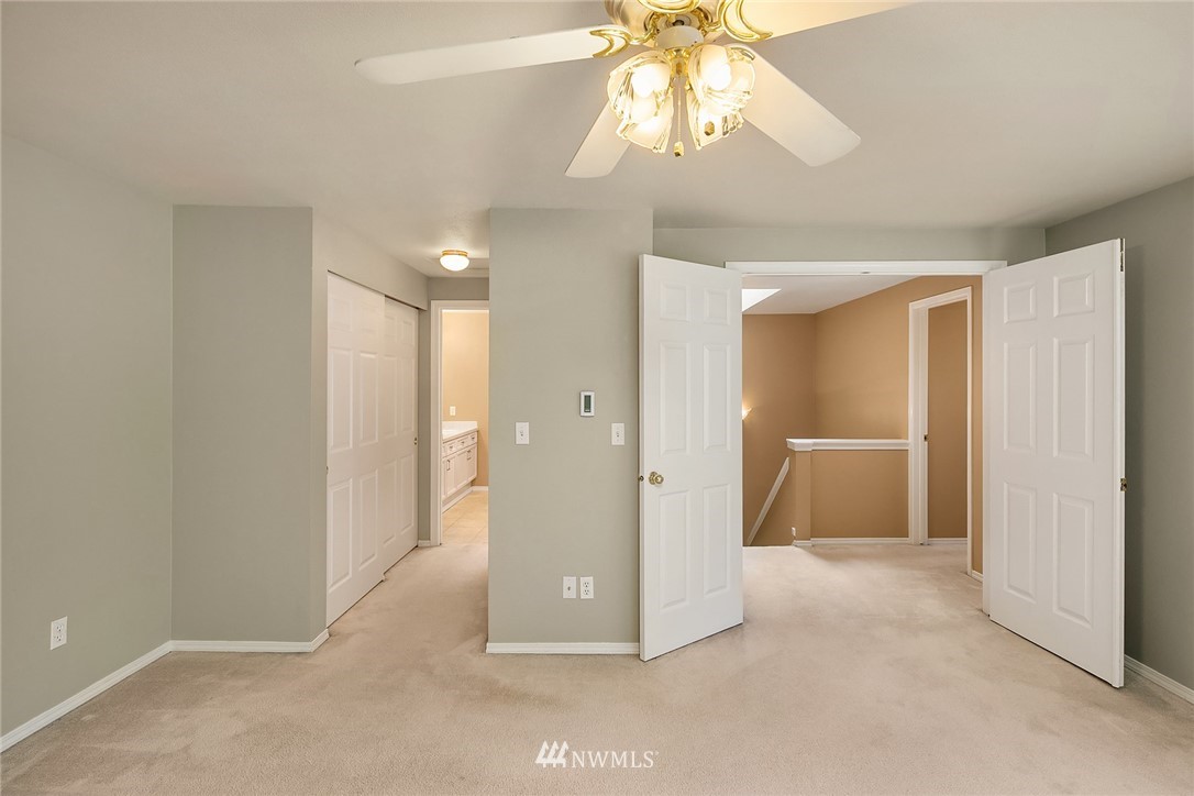 10909 Avondale Road Northeast, Unit F122 Redmond, WA 98052 - Photo 18 of 24 a view of a hallway with a chandelier fan and a livingroom