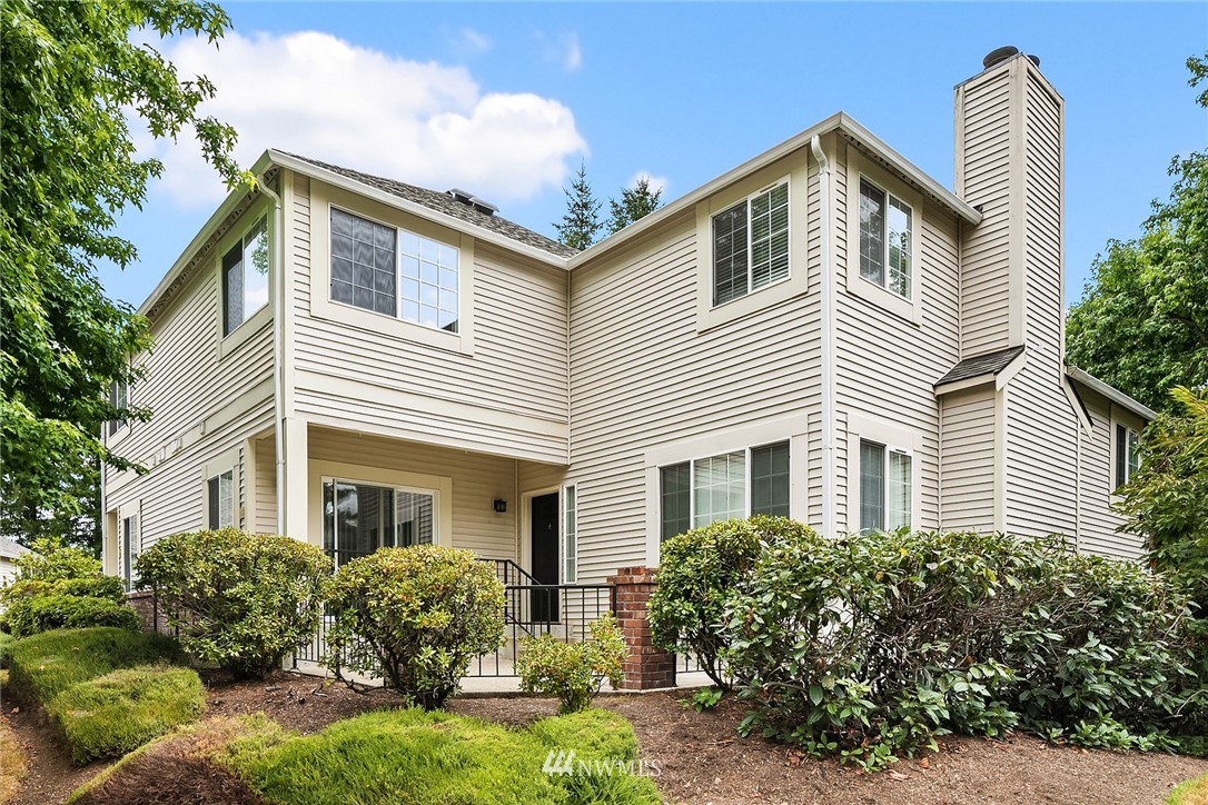 10909 Avondale Road Northeast, Unit F122 Redmond, WA 98052 - Photo 3 of 24 a front view of a house with a yard