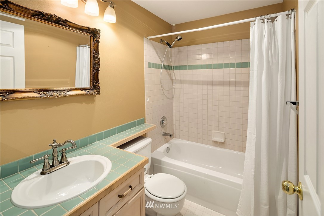 10909 Avondale Road Northeast, Unit F122 Redmond, WA 98052 - Photo 22 of 24 a bathroom with a sink toilet and shower