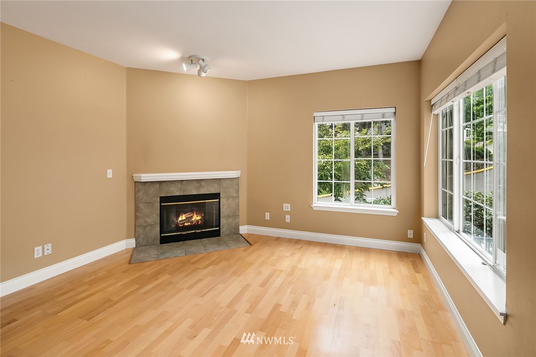 10909 Avondale Road Northeast, Unit F122 Redmond, WA 98052 - Photo 6 of 24 a view of an empty room with a window and fireplace