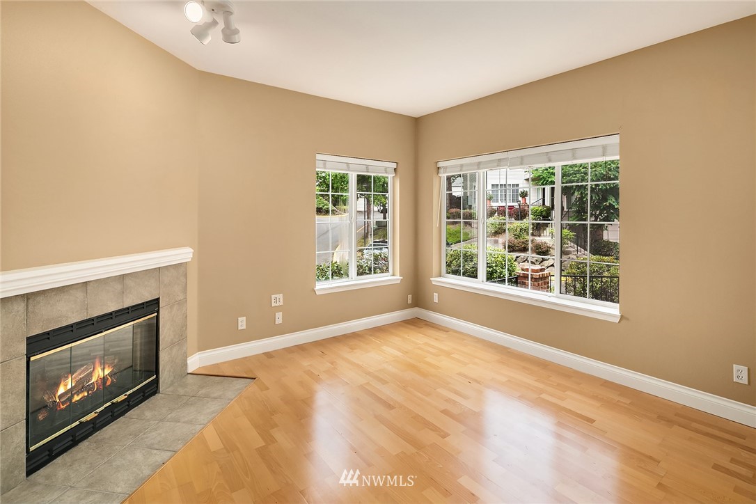 10909 Avondale Road Northeast, Unit F122 Redmond, WA 98052 - Photo 7 of 24 a view of an empty room with window and fire place