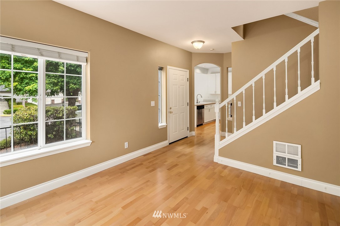 10909 Avondale Road Northeast, Unit F122 Redmond, WA 98052 - Photo 8 of 24 a view of an entryway with wooden floor and windows