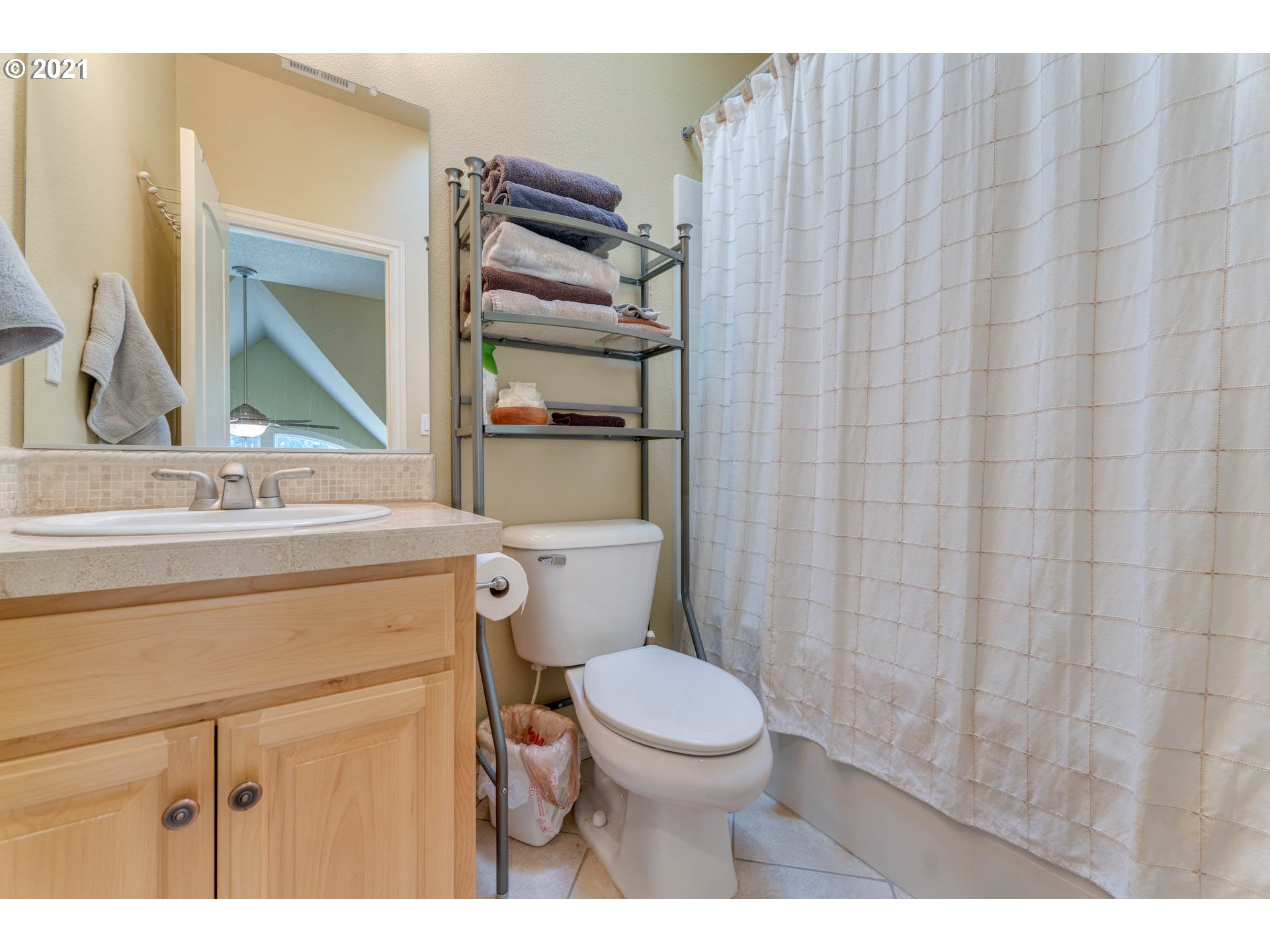 43126 Southeast Music Camp Road Sandy, OR 97055 - Photo 20 of 32 a bathroom with a sink a toilet a mirror and shower curtain
