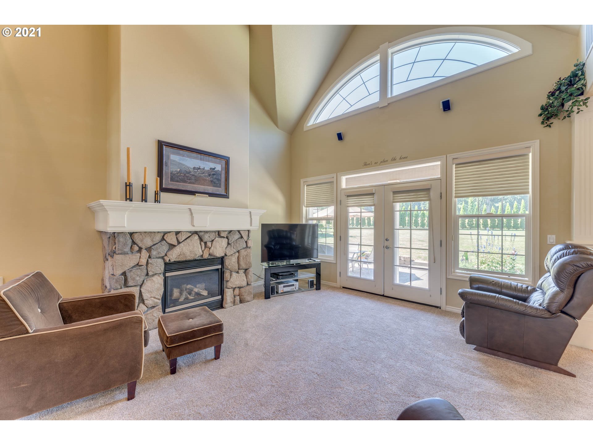 43126 Southeast Music Camp Road Sandy, OR 97055 - Photo 6 of 32 a living room with furniture a flat screen tv and a fireplace