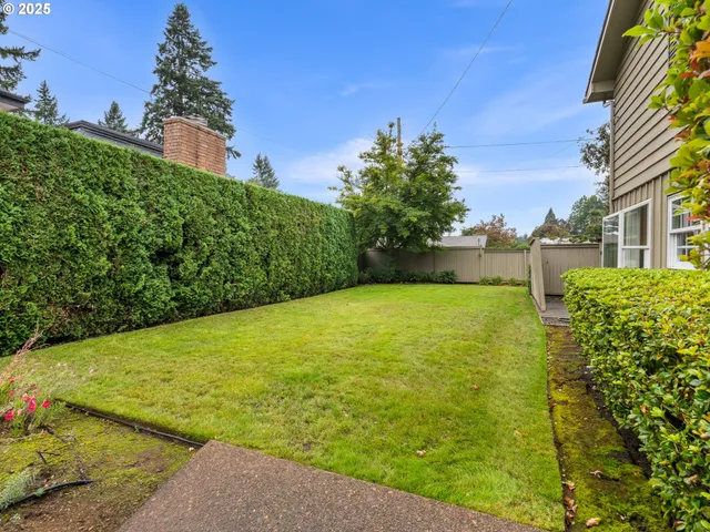 a view of a garden with a building in the background