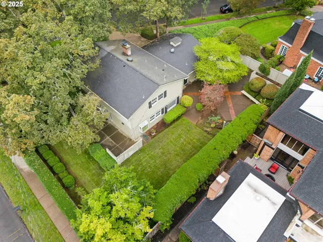 an aerial view of a house with a garden and lake view