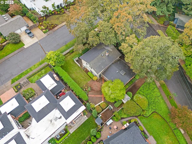 an aerial view of a house with a yard