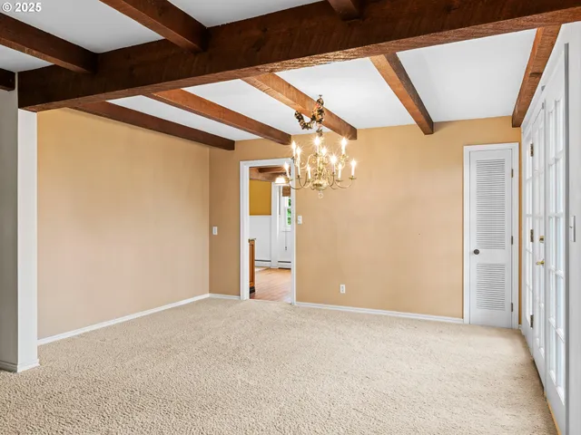 a view of a big room with wooden floor and windows