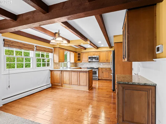 a view of a kitchen with a sink and cabinets