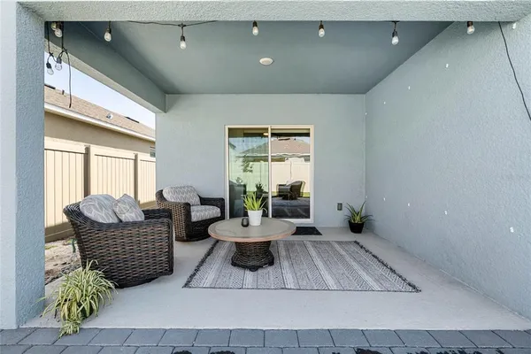 a living room with furniture rug and a window