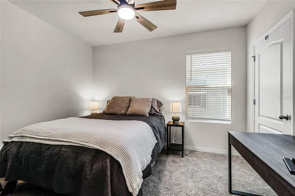 a bedroom with a bed and window