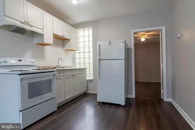a kitchen with a white cabinets and white appliances