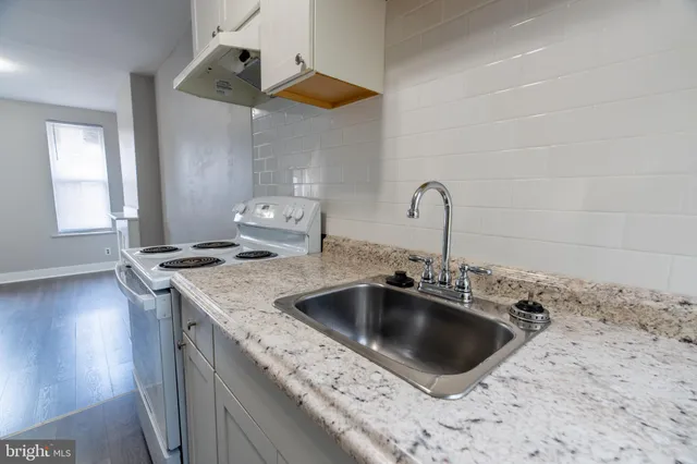 a kitchen with a sink stove and cabinets