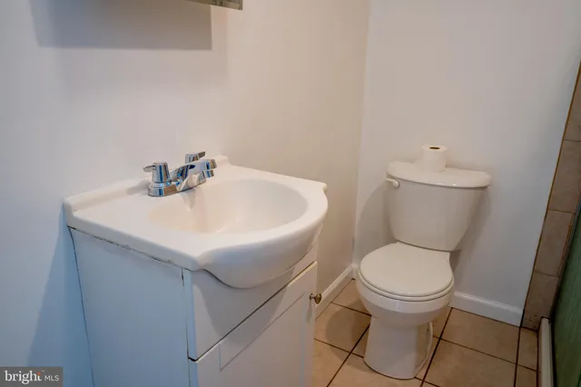 a white toilet sitting next to a bathroom sink