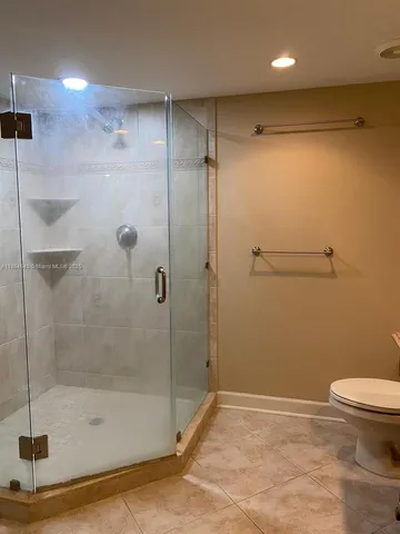 a bathroom with a shower and a toilet