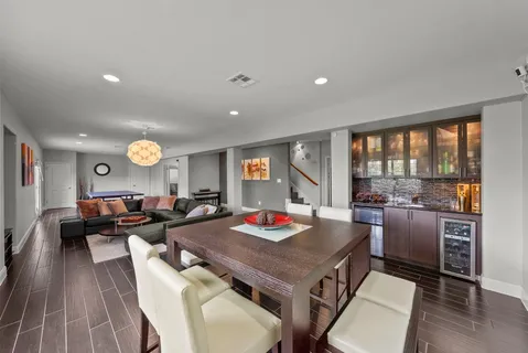 a living room with furniture and a floor to ceiling window