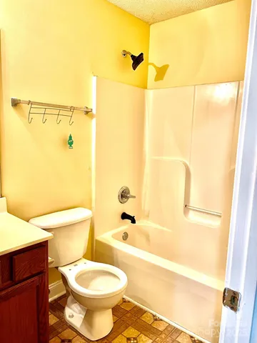 a bathroom with a toilet and a bathtub