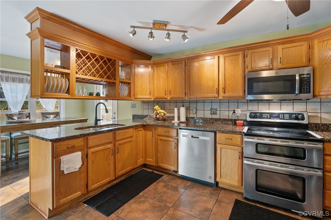 4212 Stigall Drive Chesterfield, VA 23112 - Photo 10 of 35 a kitchen with stainless steel appliances a stove sink microwave and cabinets