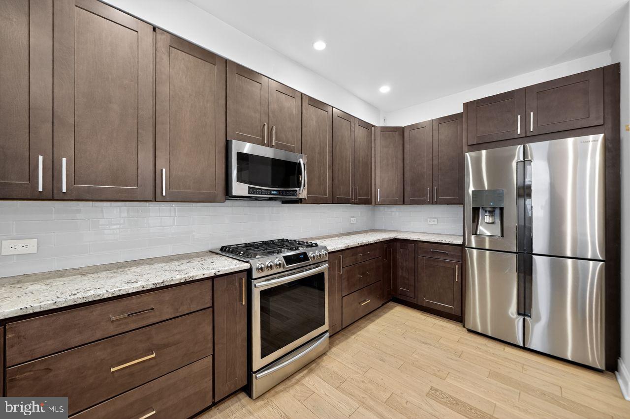 236 South 21st Street, Unit CD Philadelphia, PA 19103 - Photo 11 of 27 a kitchen with a refrigerator stove and microwave