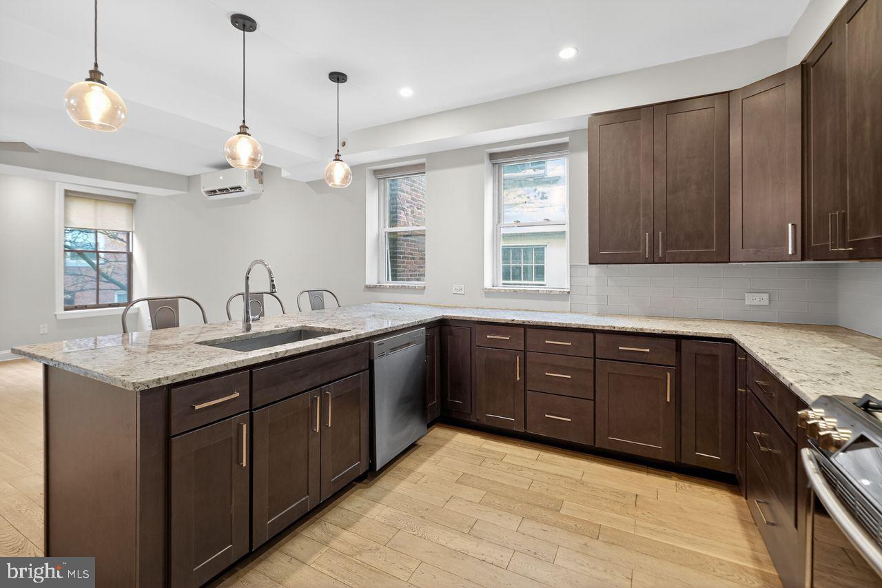 236 South 21st Street, Unit CD Philadelphia, PA 19103 - Photo 13 of 27 a kitchen with a sink and wooden cabinets
