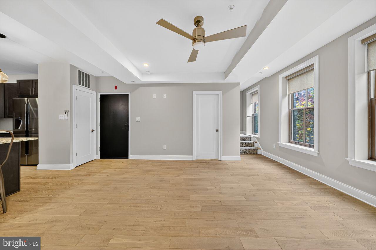 236 South 21st Street, Unit CD Philadelphia, PA 19103 - Photo 5 of 27 a view of a livingroom with a ceiling fan and window