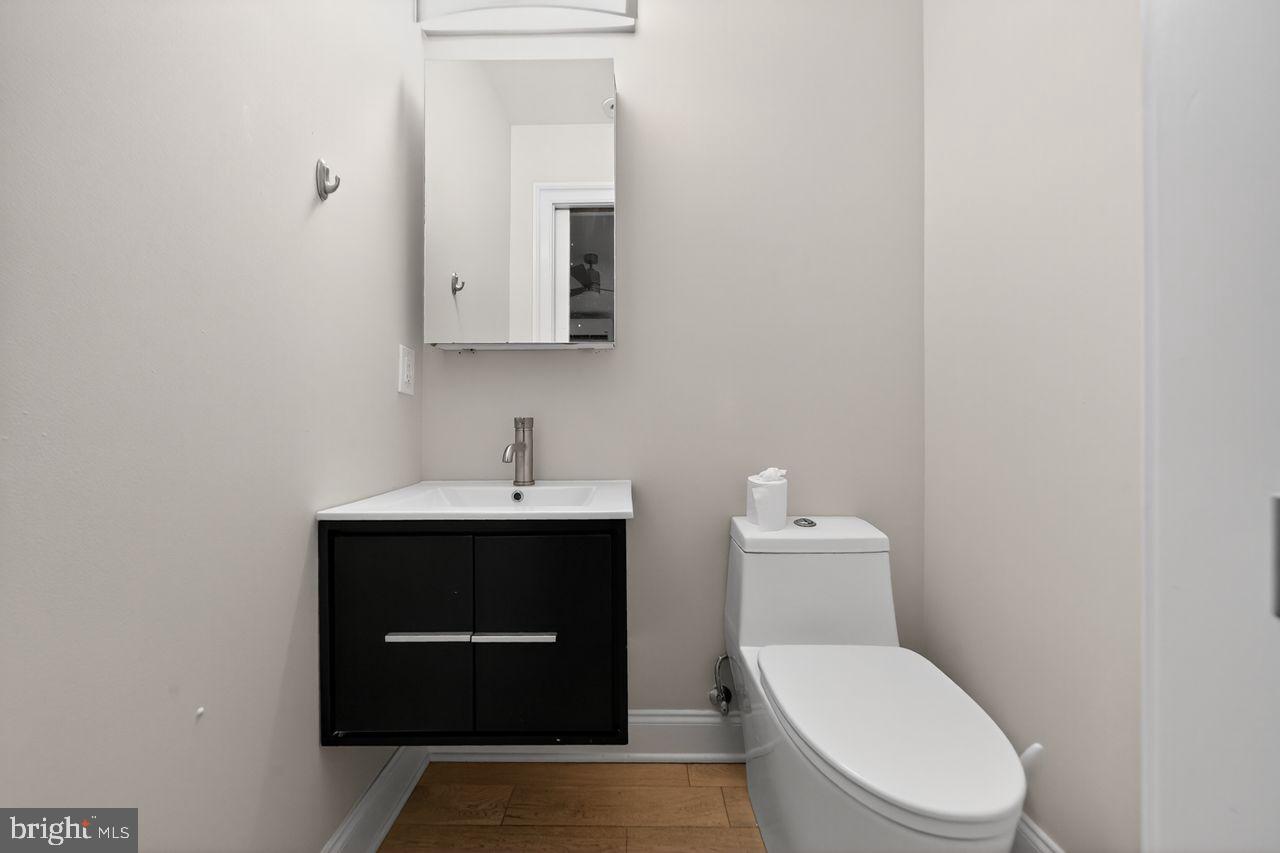 236 South 21st Street, Unit CD Philadelphia, PA 19103 - Photo 6 of 27 a bathroom with a toilet a sink and mirror